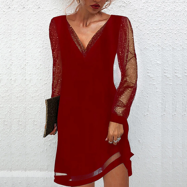 Abito donna elegante a tubino con maniche scintillanti e scollatura a V, perfetto per serate autunnali e feste glamour.