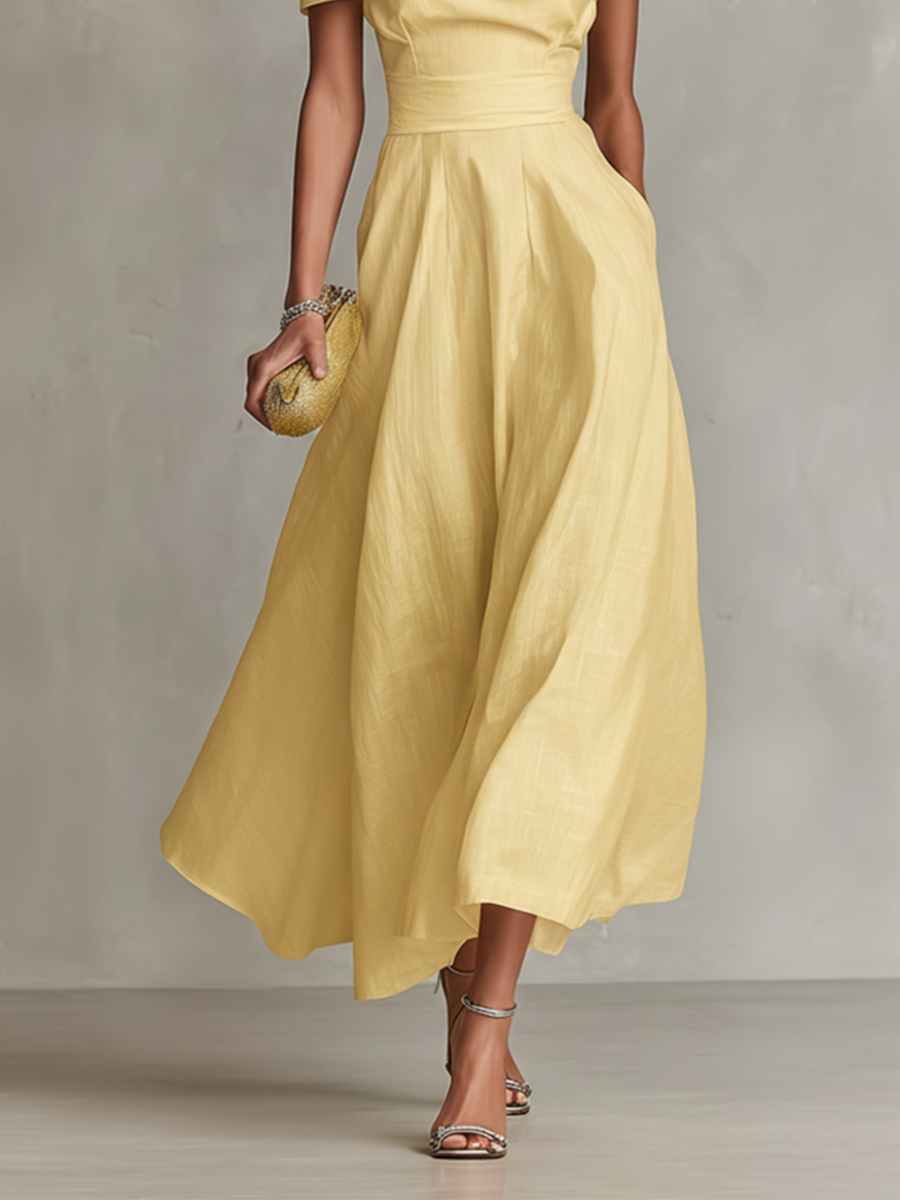 Elegante abito in lino giallo monospalla per donna, capo essenziale per un guardaroba estivo sofisticato e di tendenza.