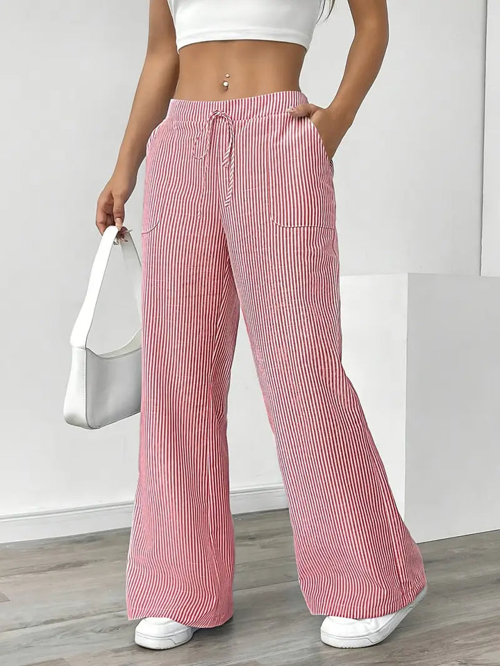 Pantaloni donna a righe verticali, larghi e comodi, perfetti per la moda estiva.