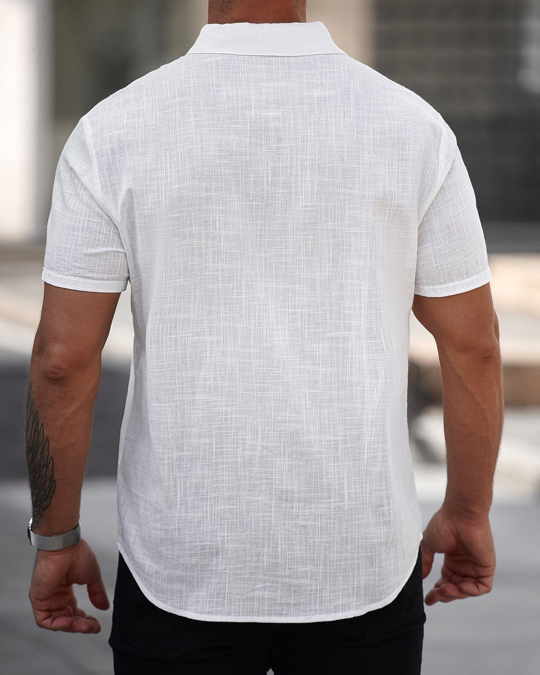 Elegante camicia uomo a maniche corte bianca con taschino, ideale per outfit casual estivi e moda vacanza.
