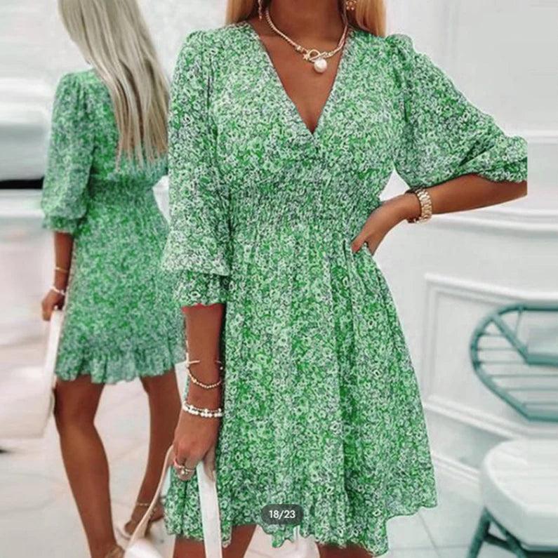Abito floreale midi donna con scollo a V, maniche a sbuffo e vestibilità fluida, ideale per un look chic estivo.