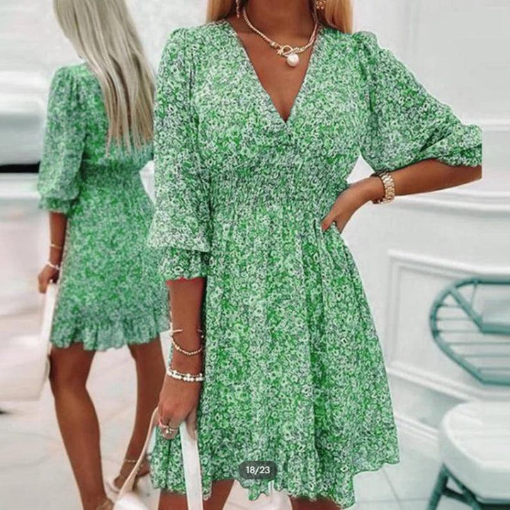 Abito floreale midi donna con scollo a V, maniche a sbuffo e vestibilità fluida, ideale per un look chic estivo.