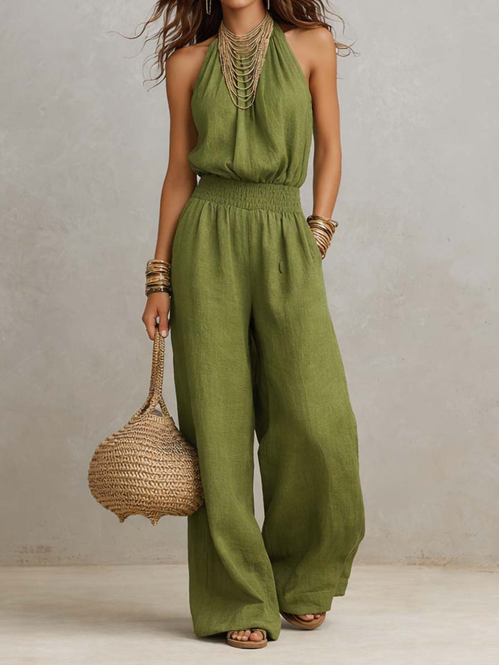 Elegante tuta estiva donna con scollo halter, vita definita e pantaloni ampi. Ideale per un look sofisticato.