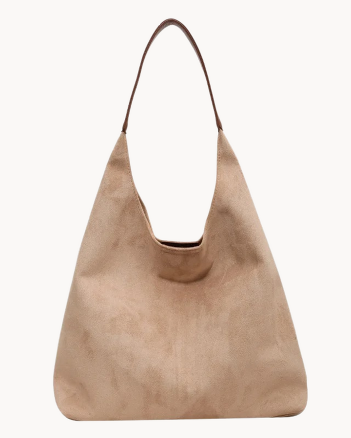 Borsa hobo donna in morbida pelle scamosciata, texture lussuosa. Accessorio moda elegante e versatile per ogni outfit.