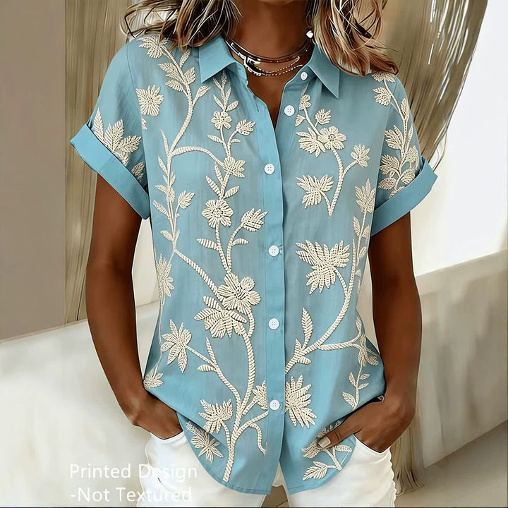 Blusa floreale da donna con stampa botanica colorata, maniche corte. Perfetta per la moda estiva.