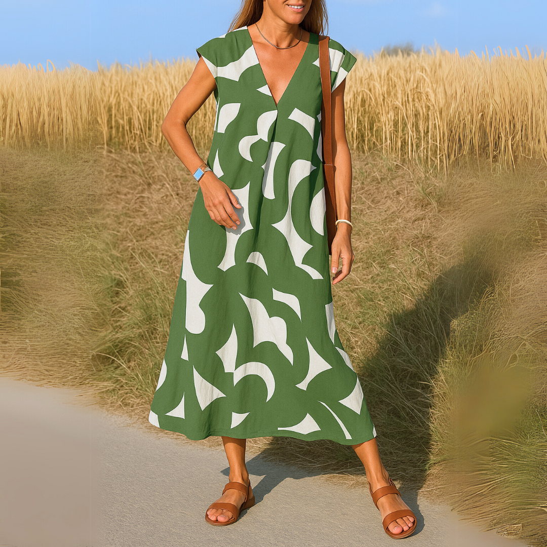 Abito midi donna con distintiva stampa geometrica e scollo a V, stile casual-elegante.