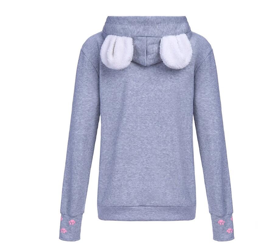 Donna indossa felpa con cappuccio e stampa gatto, mostrando comfort e stile casual rilassato e alla moda.