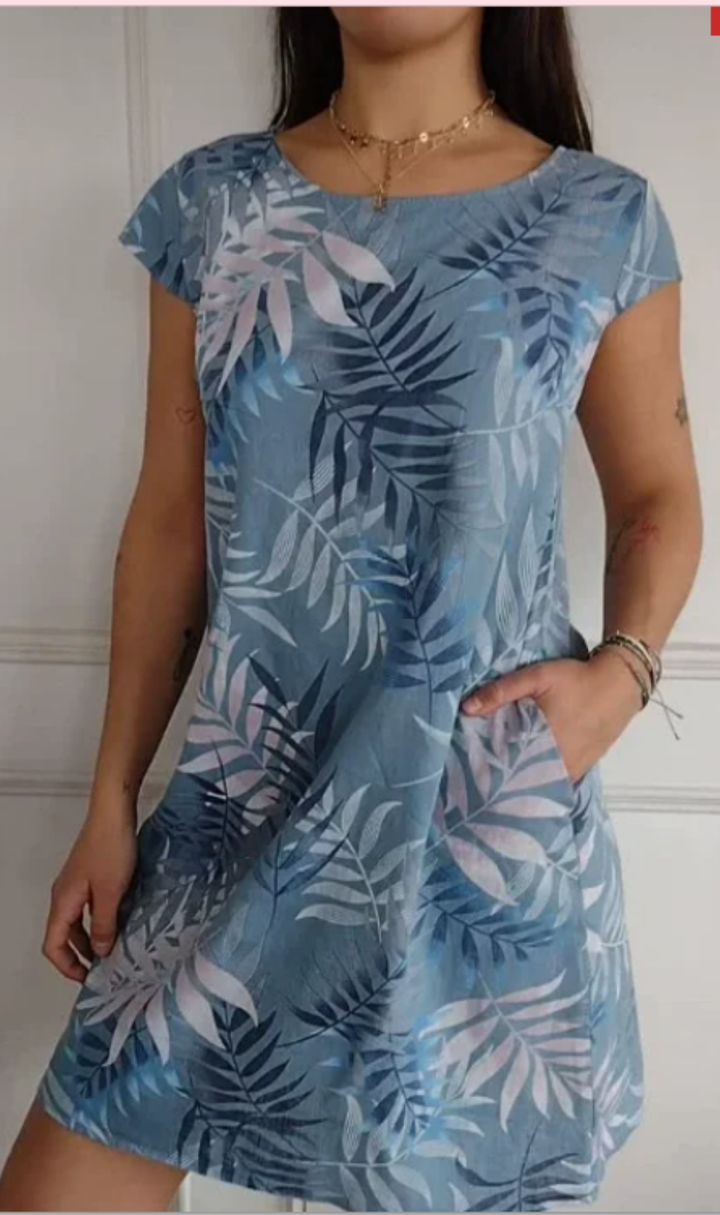 Abito donna primaverile con stampa botanica, linea fluida e tasche, per un look fresco e chic.