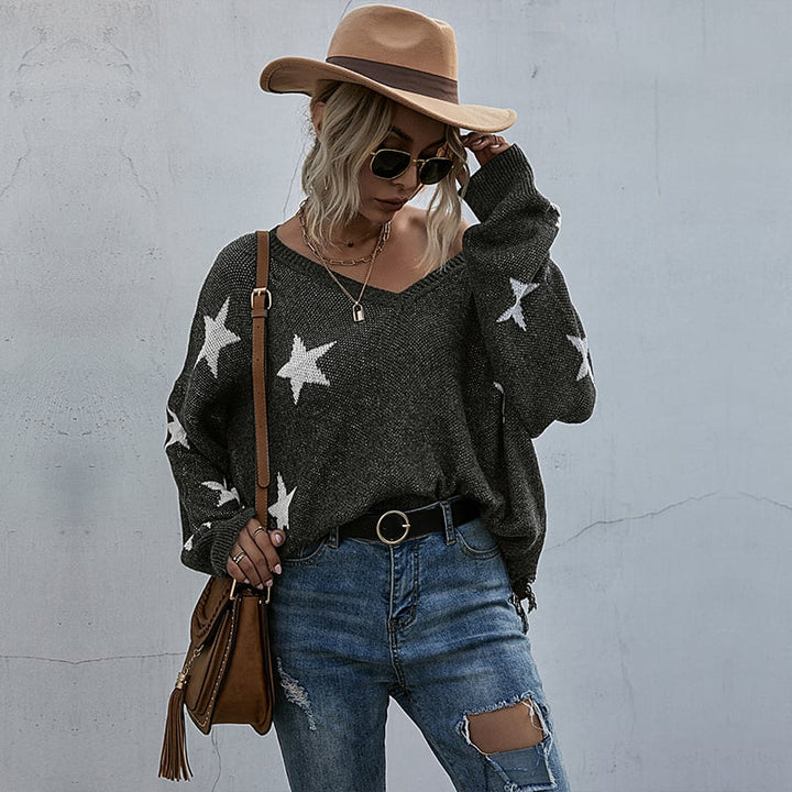 Elegante maglione da donna grigio con stelle e nappine, pullover caldo per i tuoi look autunno-inverno.