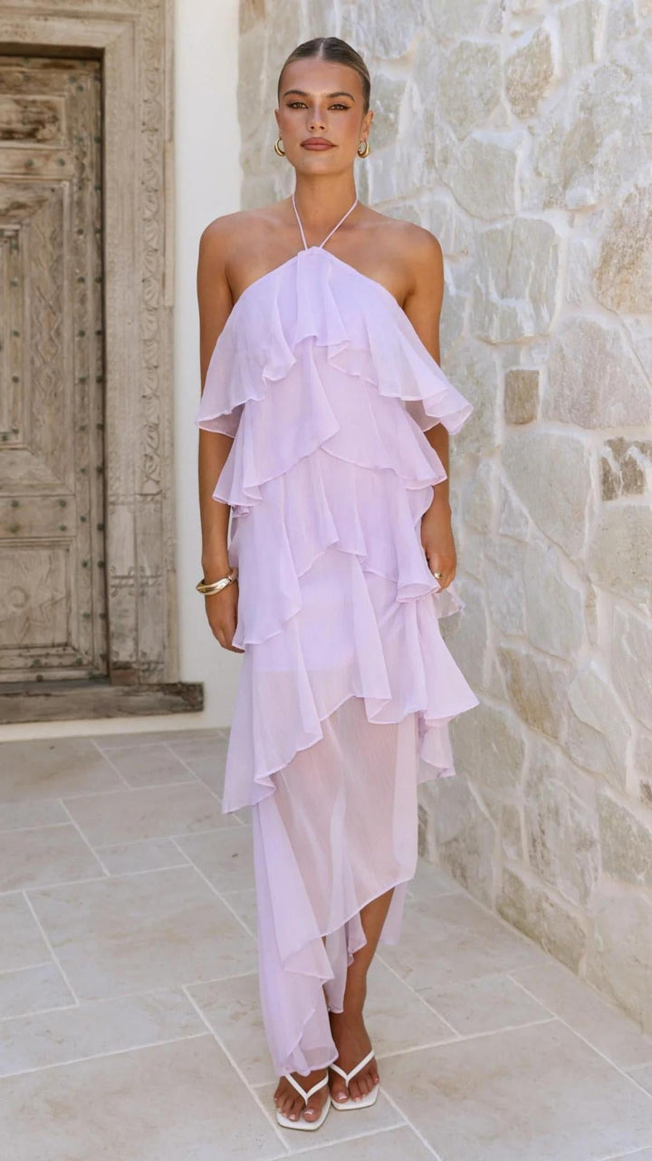Moda mare: abito lungo femminile con stampa floreale colorata e dettagli spalle scoperte.