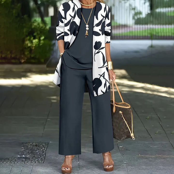 Completo donna moderno tre pezzi con giacca floreale e pantaloni eleganti. Abbigliamento chic e versatile.