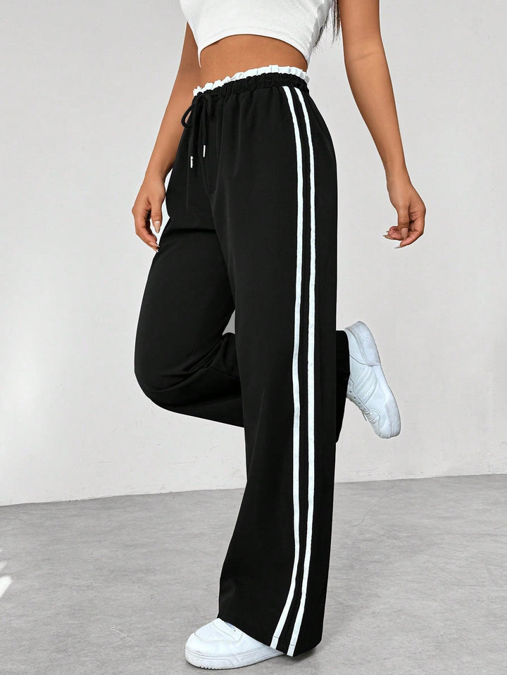 Eleganti pantaloni sportivi donna a gamba larga, perfetti per un look streetwear comodo e alla moda.