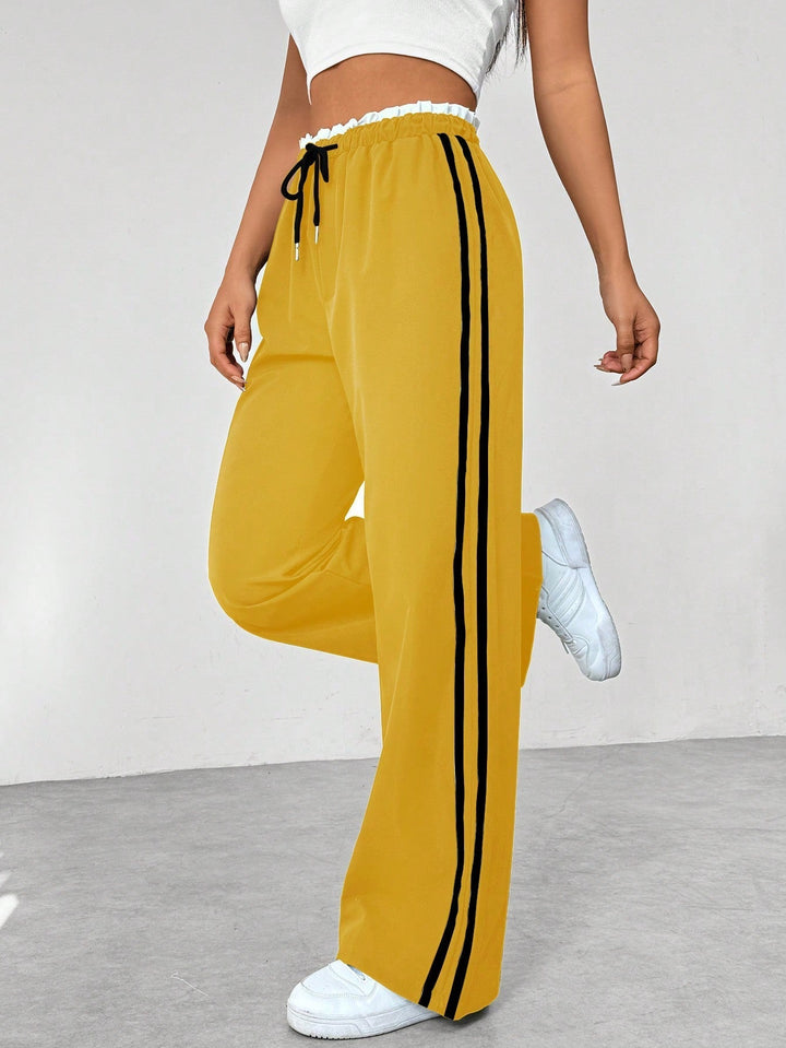 Pantaloni sportivi donna leggeri a gamba larga, tessuto confortevole ideale per primavera ed estate.