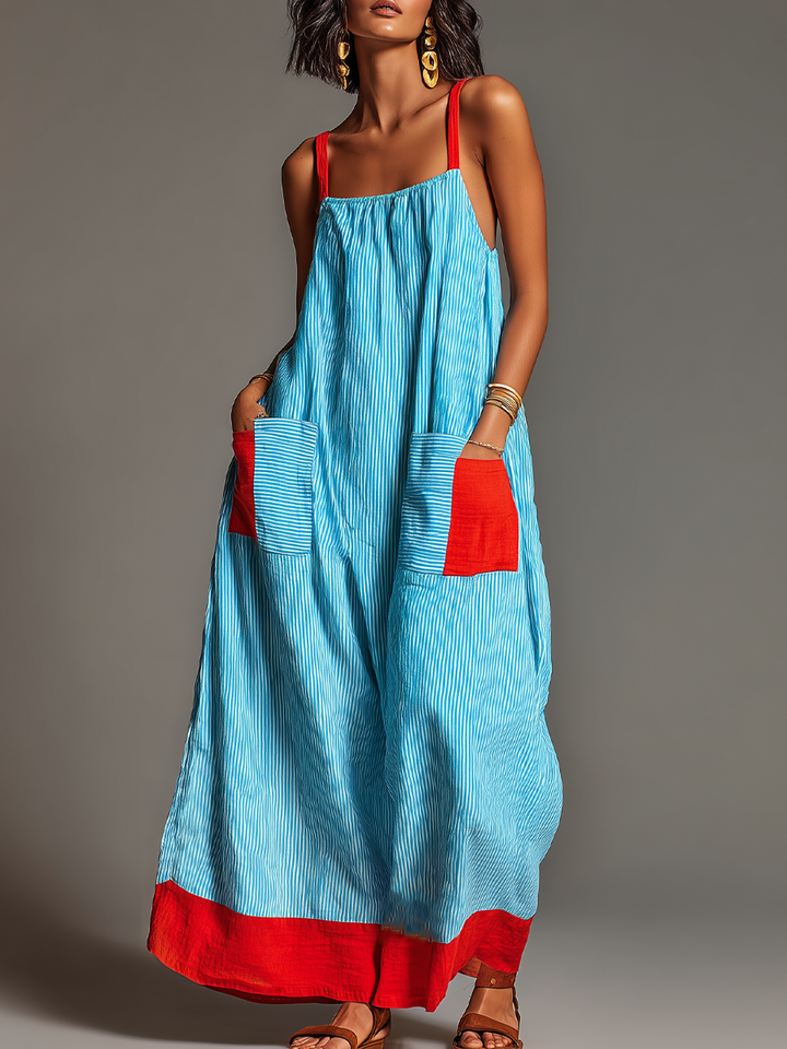 Abito maxi da donna estivo a righe con spalline sottili e tasche laterali, ideale per un look fluido e casual chic.