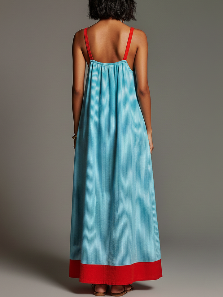 Abito estivo fluido da donna, taglio maxi, con motivo a righe e pratiche tasche. Perfetto per la moda mare.