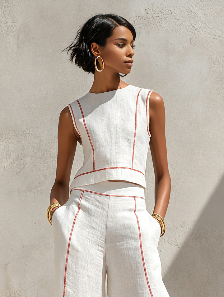 Set donna due pezzi: top senza maniche e pantaloni ampi. Design minimal con cuciture a contrasto per un outfit versatile.