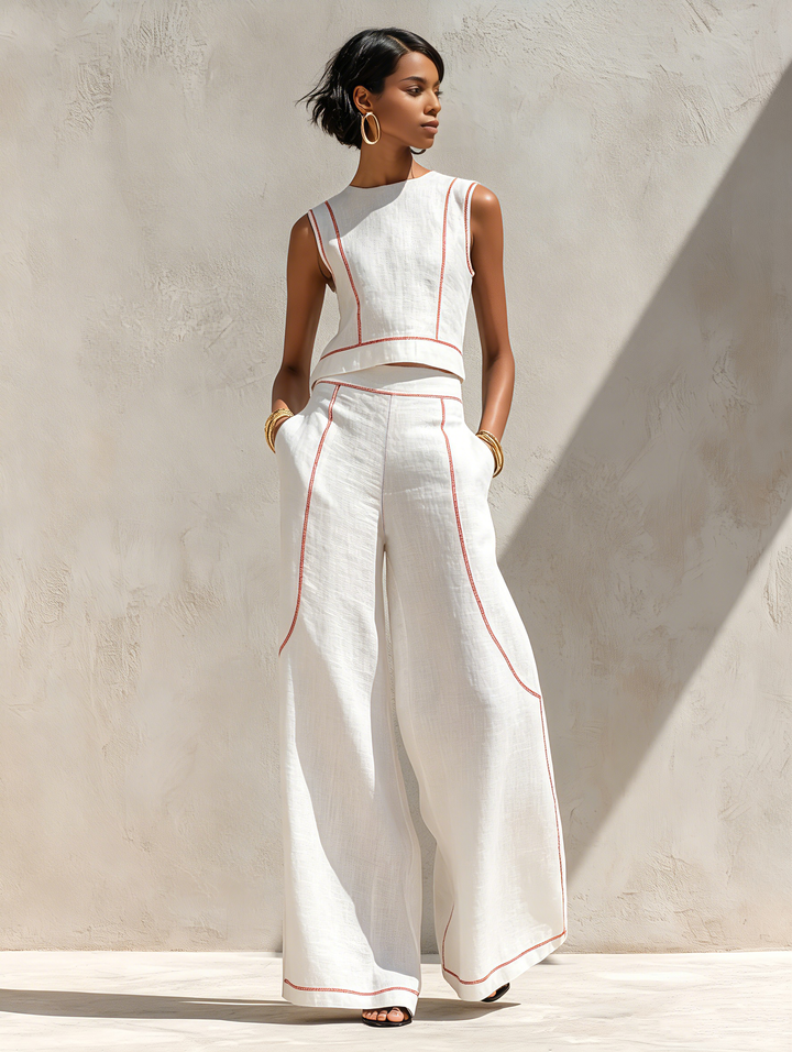 Abbigliamento donna: completo minimal chic con pantaloni ampi e top senza maniche, valorizzato da cuciture a contrasto.