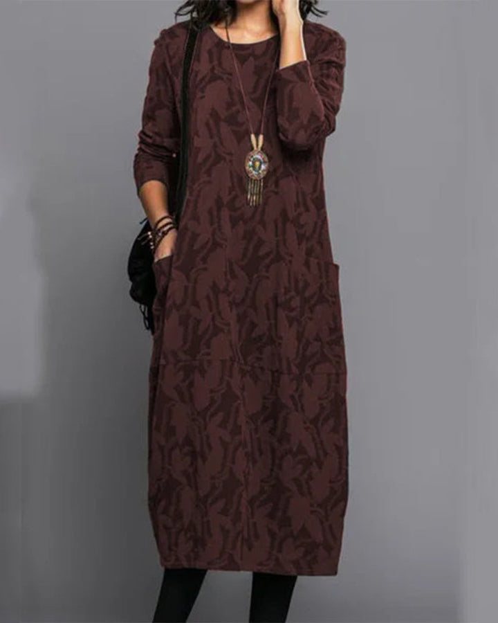 Abito midi elegante da donna per l'autunno, con maniche lunghe, stampa esclusiva e pratiche tasche laterali.