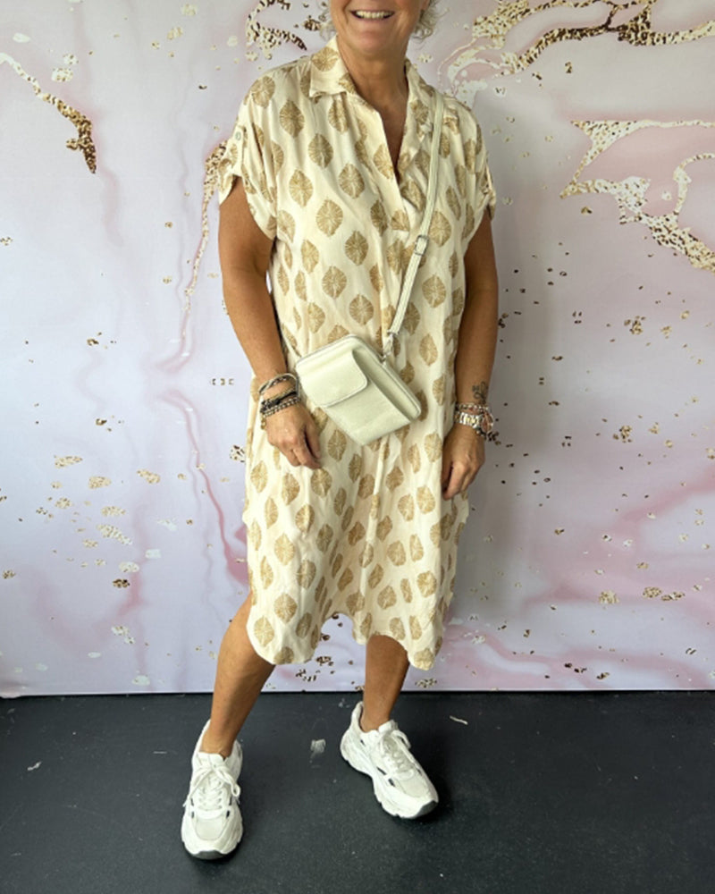 Abito donna estivo midi versatile, con scollo a V. Crea un look casual ed elegante per la moda estiva.
