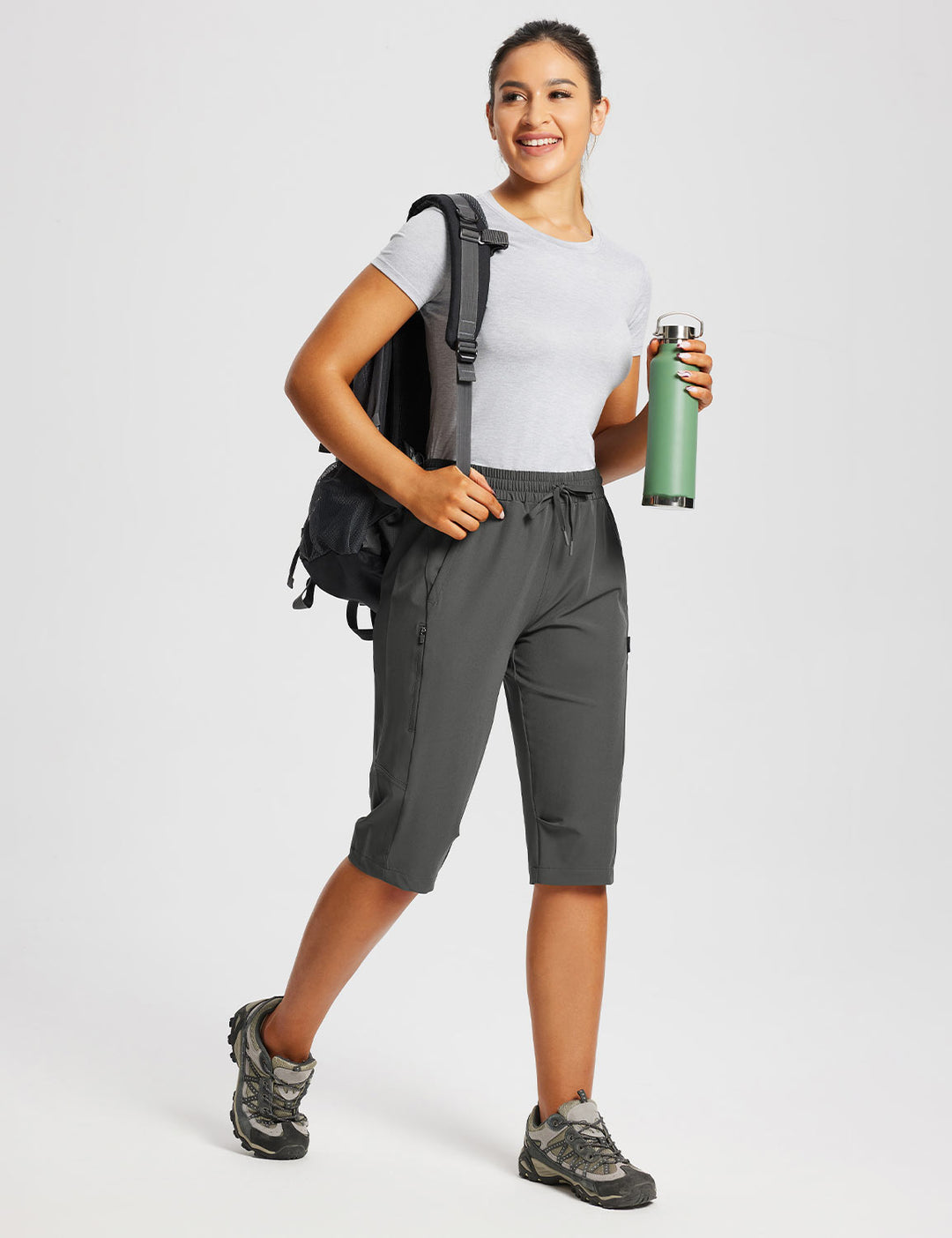 Capri donna per fitness, con tasche laterali elastiche per borraccia e accessori.