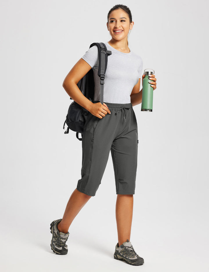 Capri donna per fitness, con tasche laterali elastiche per borraccia e accessori.