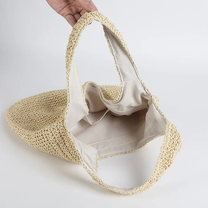 Borsa grande da spiaggia donna in paglia intrecciata, con dettagli alla moda, perfetta per un'estate elegante.