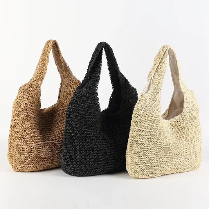 Borsa estiva da donna in paglia intrecciata, ideale per un look casual e l'eleganza estiva in spiaggia.