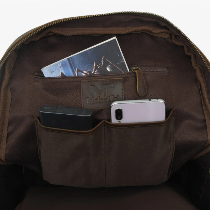 Dettaglio zaino marrone unisex: cerniere robuste e scomparti interni organizzati.