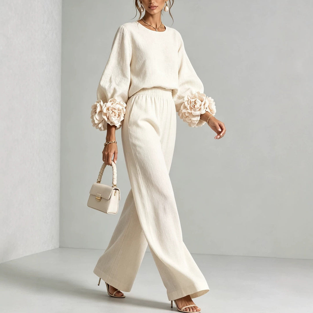 Modella indossa set donna casual chic con top floreale e pantaloni ampi. Abbigliamento comodo ed elegante multi colore.
