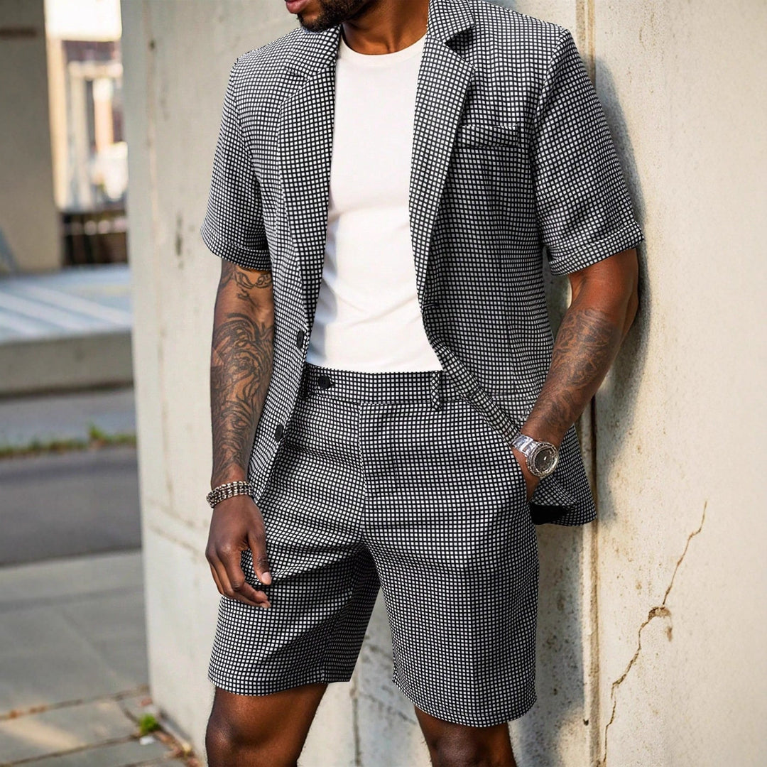 Completo uomo slim fit a quadri nero, giacca e pantaloni due pezzi, stile elegante e business formale.