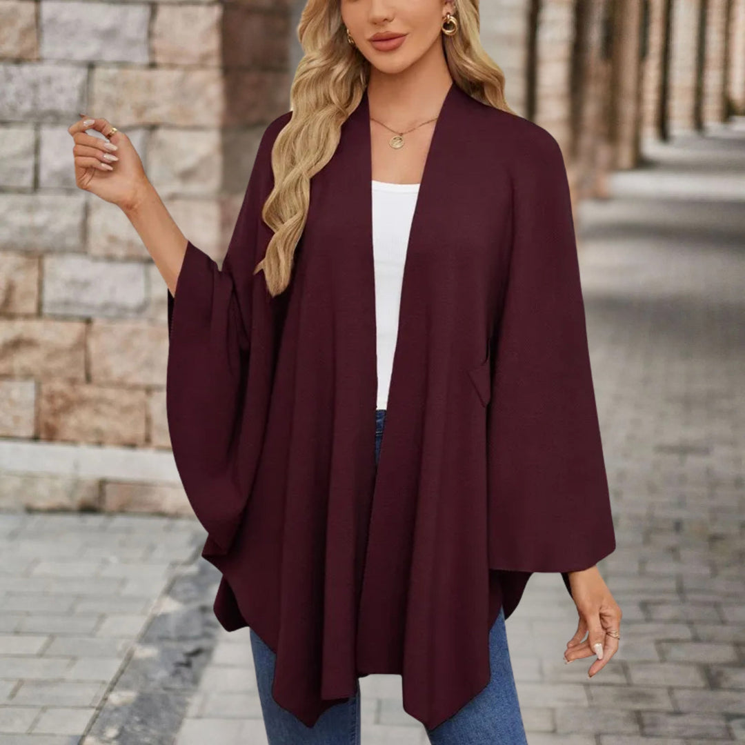 Poncho donna raffinato con fiocco. Stile elegante e chic, garantisce comfort e versatilità.