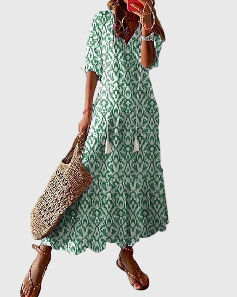 Vestito maxi boho fluido da donna, ideale per l'autunno, con silhouette elegante e tessuto leggero.