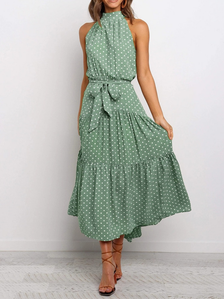 Abito midi donna con stampa a pois, taglio svasato, scollo all'americana e cintura. Eleganza estiva.