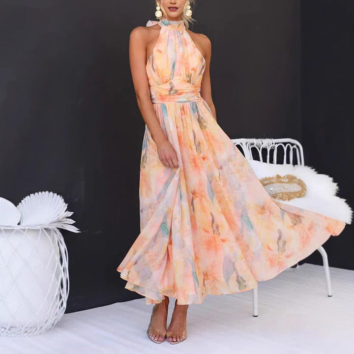 Abito estivo donna lungo con schiena scoperta e stampa corallo. Perfetto per un look casual chic in vacanza.