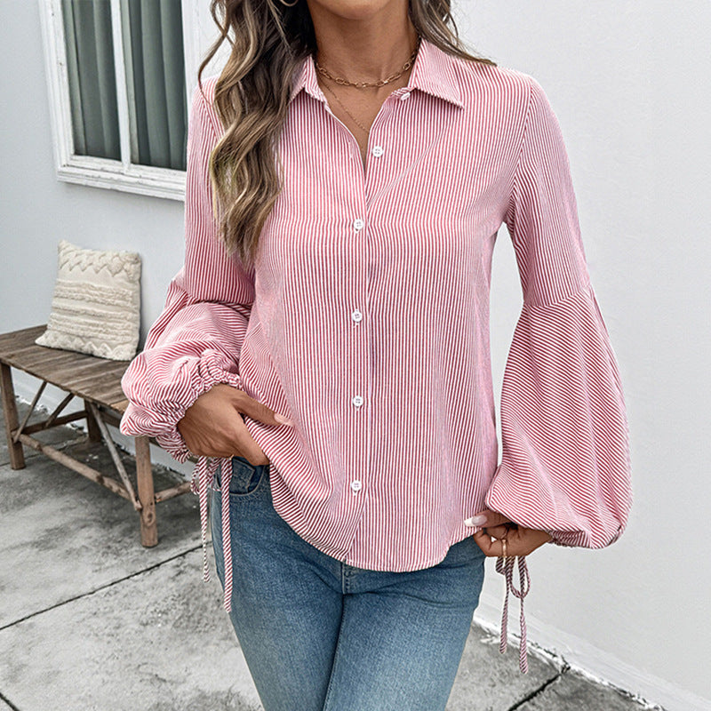 Camicia moda donna a righe con distintive maniche a lanterna, ideale per un tocco di eleganza moderna.