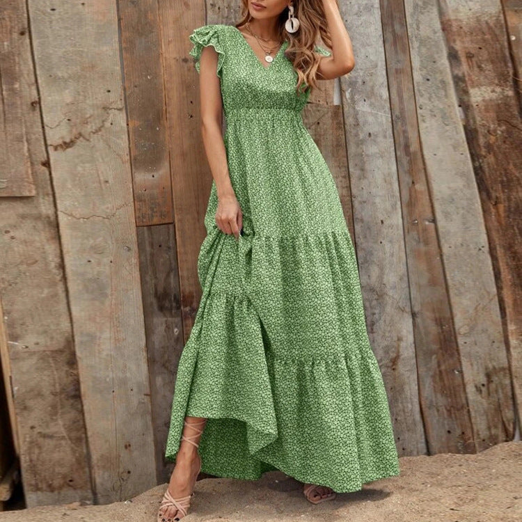 Primo piano su stampa floreale di un maxi abito estivo bohemien da donna con scollo a V. Colori vivaci.