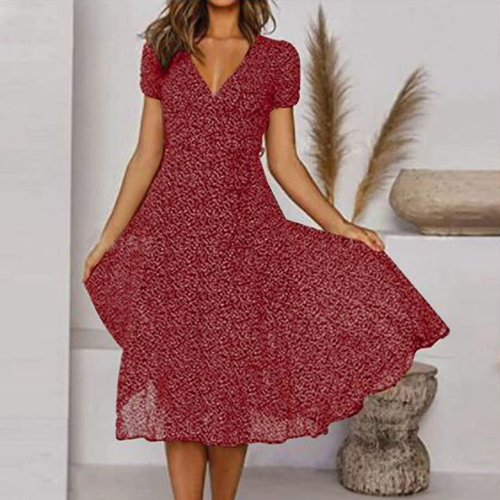 Abito midi donna con scollo a V, taglio linea A e gonna fluida, ideale per look primaverili estivi eleganti e casual.