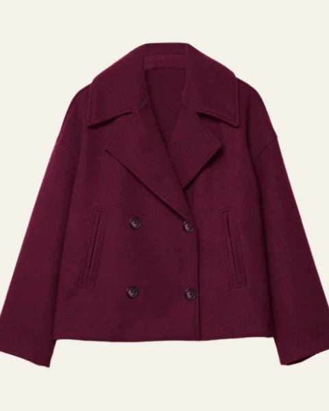 Elegante giacca corta doppiopetto da donna, in caldo effetto lana, ideale per serate autunnali.
