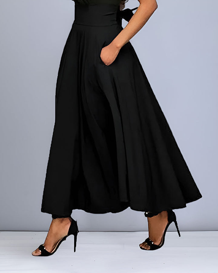 Gonna midi donna elegante in tessuto fluido, vita alta, un capo di moda irrinunciabile per la stagione.