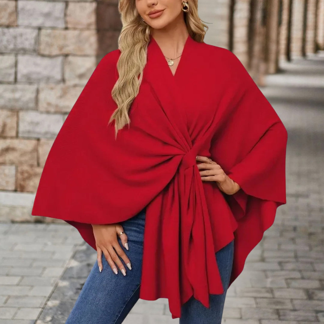 Poncho elegante da donna con fiocco decorativo. Capo chic e versatile, aggiunge comfort al look.