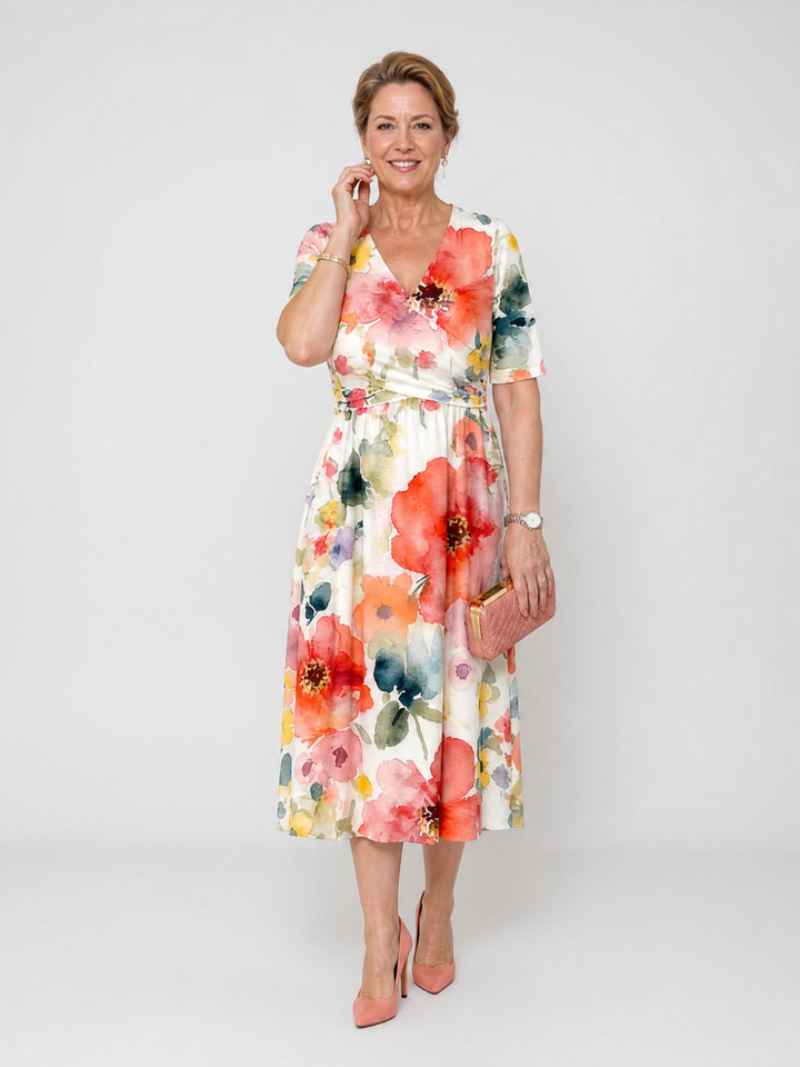 Abito da donna midi floreale leggero, ideale come vestito estivo da giorno. Scollo a V e maniche corte.