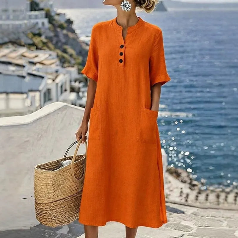 Dettaglio abito midi donna cotone lino con bottoni frontali e tasche laterali, stile casual-elegante.