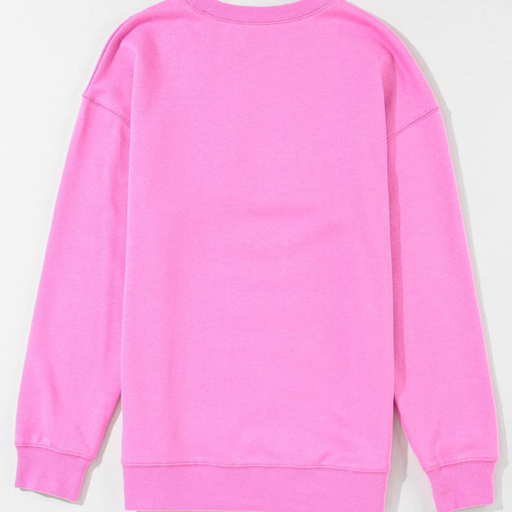 Pullover donna oversize rosa a manica lunga con scollo tondo e stampa lettering, ideale per outfit casual chic.