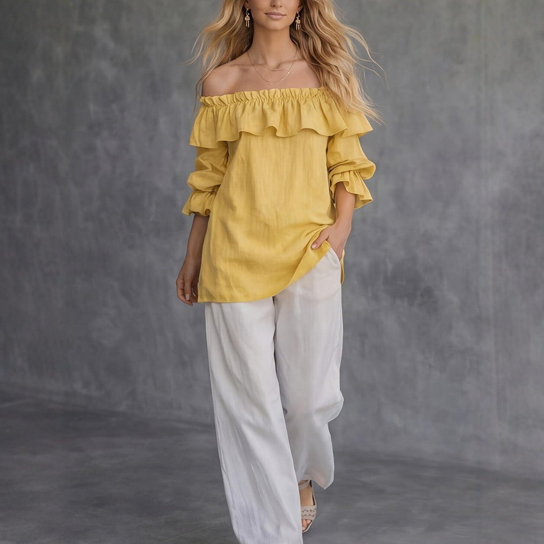 Top donna monospalla chic con volant e maniche a sbuffo, perfetto per look estivi femminili e di tendenza.