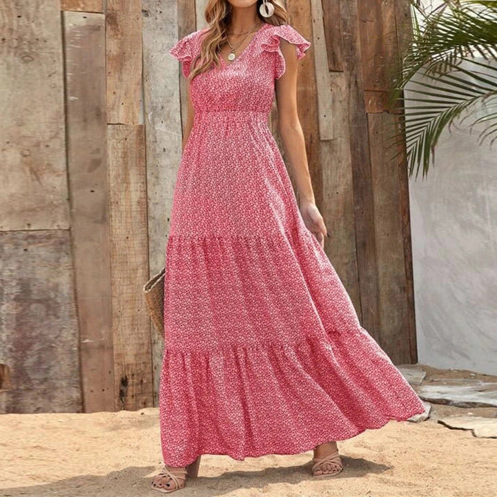 Abito estivo donna bohemien, taglio maxi, con scollo a V e fantasia floreale. Ideale per outfit vacanzieri.