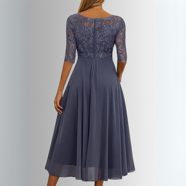 Donna che indossa un abito midi elegante con corpetto in pizzo e gonna fluida, per occasioni speciali.