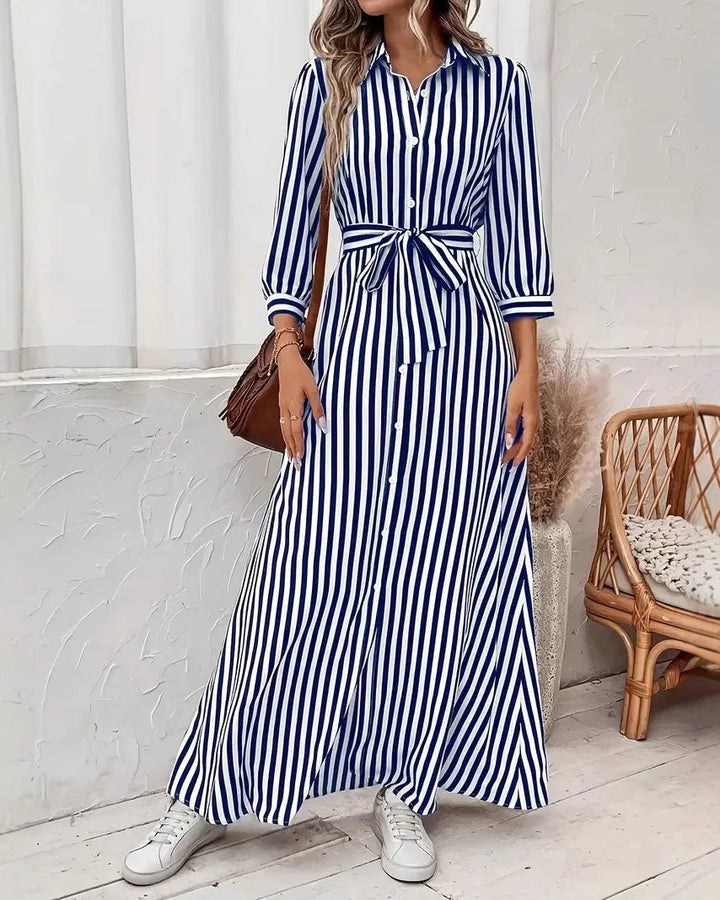 Abito camicia donna a righe, stile moderno con colletto a rever, bottoni e taglio lungo, per un look sofisticato.