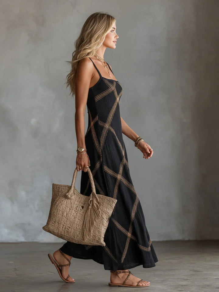 Modella indossa abito lungo estivo in poliestere leggero con motivo geometrico e spalline. Perfetto per il mare.
