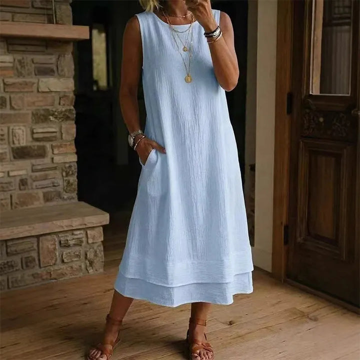 Abito midi donna smanicato con fondo a balza, un capo fresco e comodo per l'abbigliamento estivo.