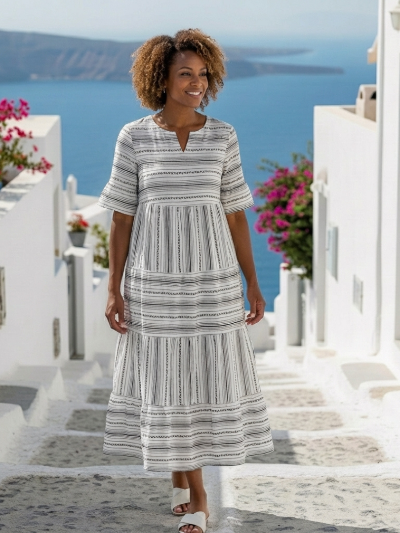 Abito midi da donna estivo con righe verticali e balze. Vestito leggero e chic, perfetto per l'estate.
